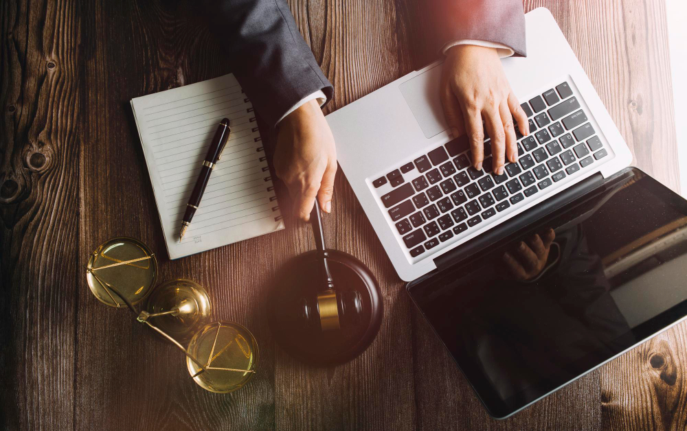 business-lawyers-discussing-contract-papers-with-brass-scale-desk-office-law-legal-services-advice-justice-law-concept-picture-with-film-grain-effect